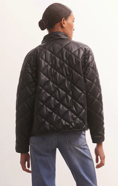 Black faux leather quilted jacket displayed on a model wearing a white t-shirt in front of a white background, showcasing the ease of wearing this jacket for your everyday look